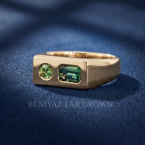 Front view of a teal and green sapphire signet ring with emerald cut and round stones set into a wide flat top geometric gemstone ring
