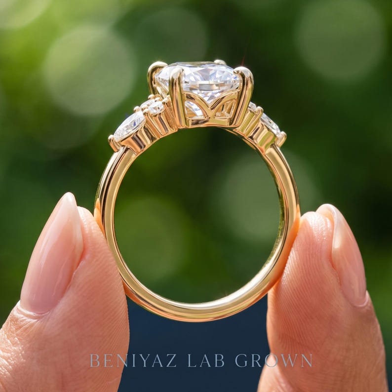 Side profile of marquise lab grown diamond engagement ring showing raised prong setting, open gallery and polished band