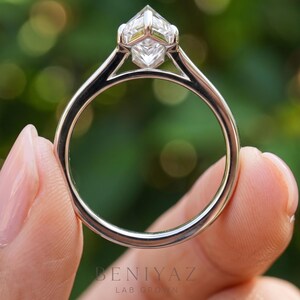 Side profile of a Dutch marquise cut lab grown diamond engagement ring displaying its elevated six-prong solitaire basket, elongated center diamond and delicate 2 mm double-line band. Detailed close-up of the ring's setting and polished finish.