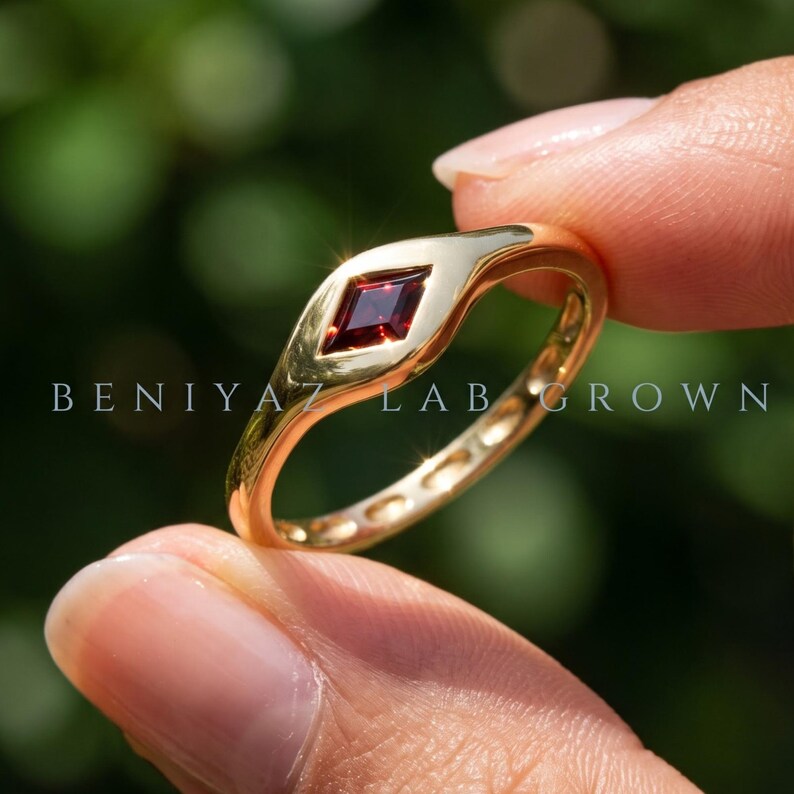 Red gemstone ring product details showing single kite set burgundy stone, tapered band and low profile geometric ring design.