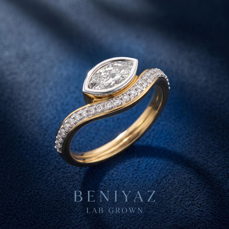 Front side view of marquise lab grown diamond engagement ring and curved wedding band, highlighting the bezel center setting and sparkling pave diamonds.