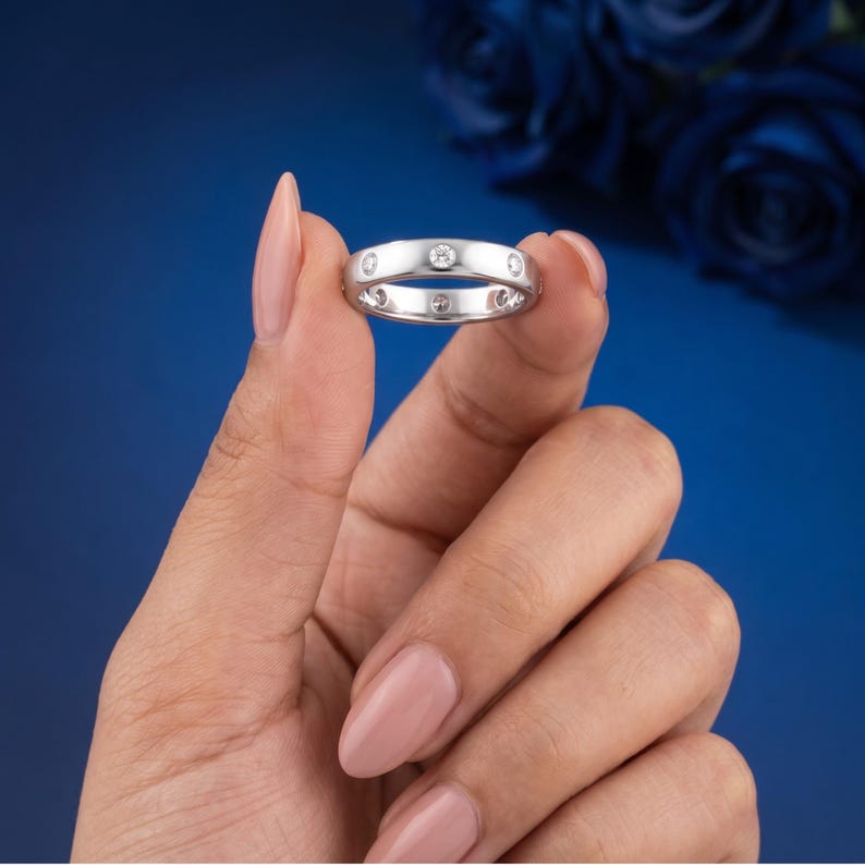 Front view of a 3.4mm flush set lab grown diamond eternity band in white gold. BENIYAZ.