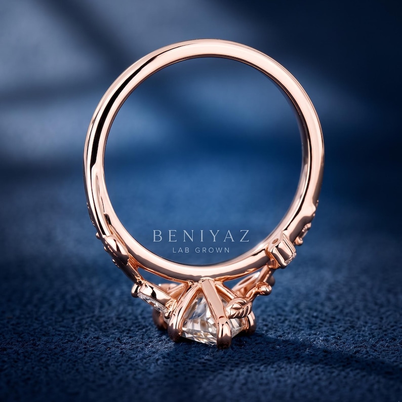 Rear profile of a vintage marquise diamond engagement ring showing the circular rose gold band, raised centre setting and detailed under-gallery.