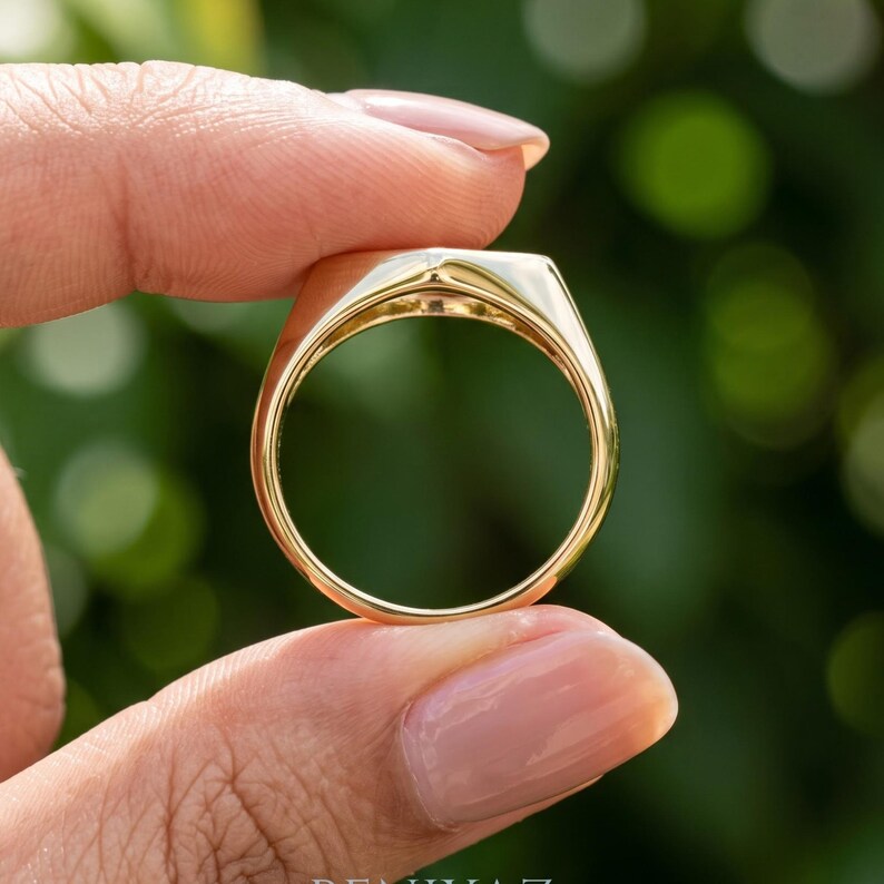 Signet ring gold side view showing the elongated geometric face, single round diamond and smooth tapered shoulders.