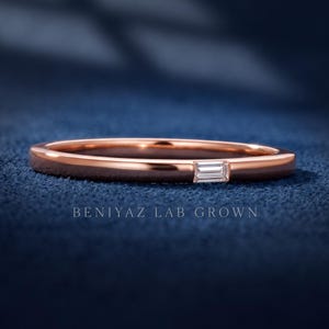 Rose gold baguette diamond wedding band with a single bar set lab grown diamond and minimalist polished finish.
