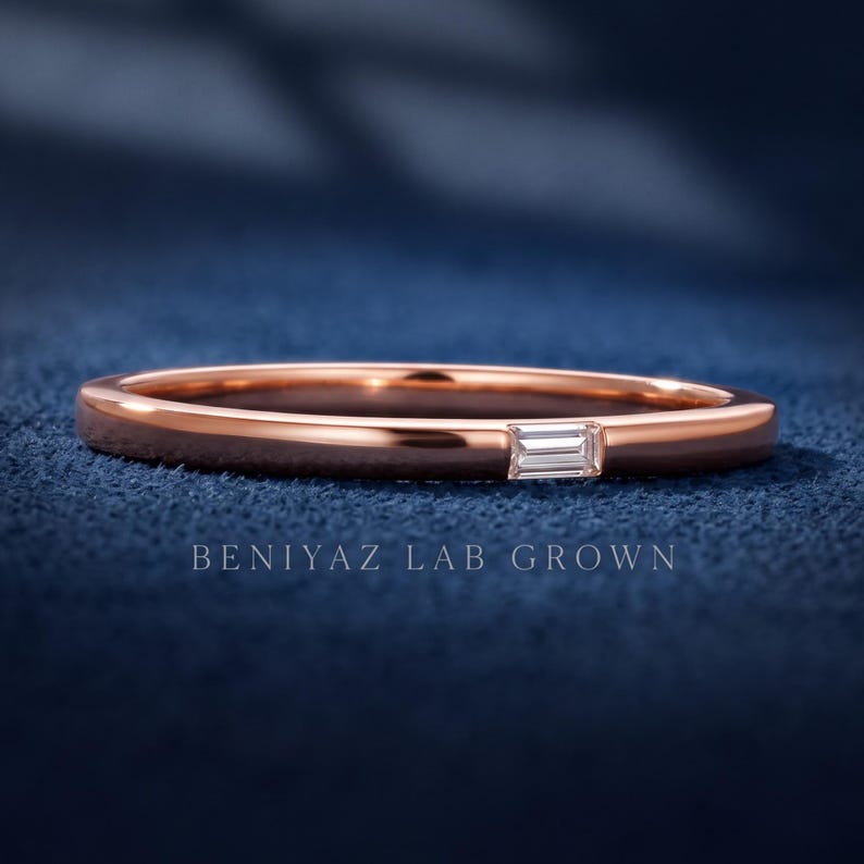 Rose gold baguette diamond wedding band with a single bar set lab grown diamond and minimalist polished finish.