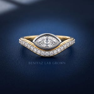 Marquise lab grown diamond engagement ring with curved diamond wedding band in yellow and white gold, front view showing ring height and detailed bridal set design.