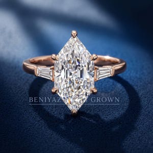 Three quarter studio view of Dutch marquise lab grown diamond engagement ring on blue velvet with polished band