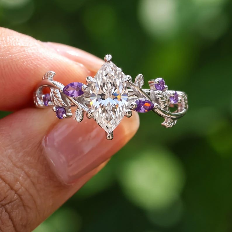 Purple gemstone ring featuring Dutch marquise lab grown diamond center with marquise and round Tanzanite accent stones.
