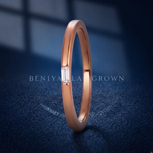 Side profile of a rose gold baguette diamond wedding band showing the slim 1.5mm band and low profile setting.
