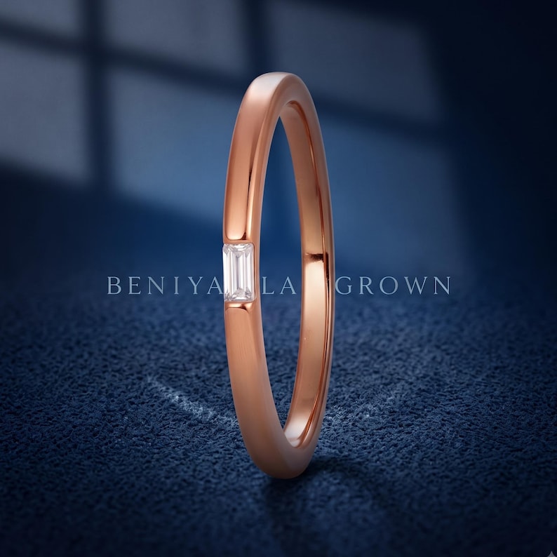 Side profile of a rose gold baguette diamond wedding band showing the slim 1.5mm band and low profile setting.