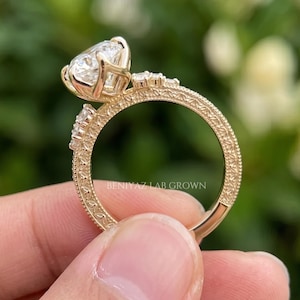 Opposite side view of a 3 carat marquise diamond ring showing the prong basket, elevated centre and detailed gold band.