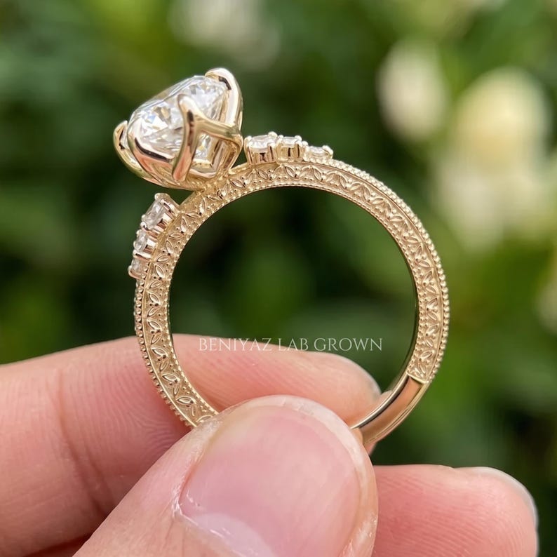Opposite side view of a 3 carat marquise diamond ring showing the prong basket, elevated centre and detailed gold band.