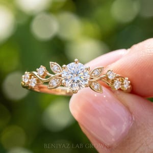 Botanical bridal engagement ring with 0.50 CT round brilliant lab grown diamond, diamond leaf accents and flowing vine design.