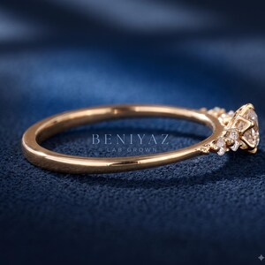 Back and side profile of a thin band lab grown diamond engagement ring showing the polished yellow gold shank and raised five stone setting.