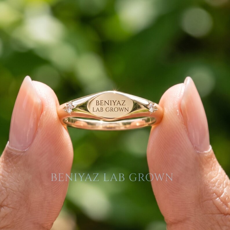 Close up hand view of a custom engraved gold wedding ring with personalized text, smooth polished finish and modern minimalist band design