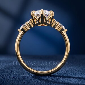 Yellow gold tone side profile of marquise engagement ring showing raised center stone, open gallery and polished band