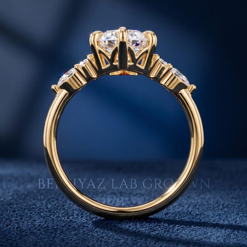 Yellow gold tone side profile of marquise engagement ring showing raised center stone, open gallery and polished band