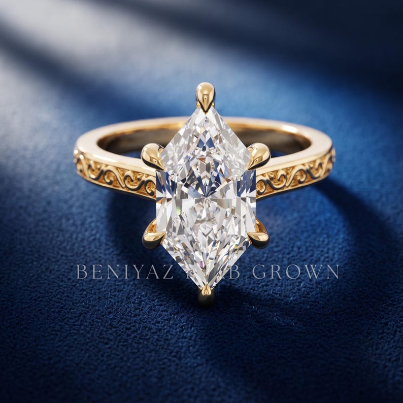 Front view of a marquise diamond engagement ring with elongated centre stone and detailed vintage inspired gold band.