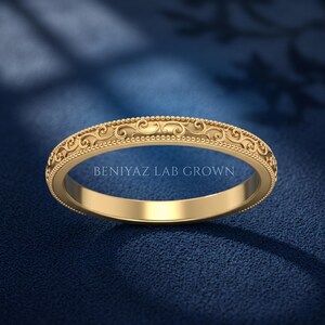 Yellow gold antique scroll stackable wedding band with ornate engraved pattern and milgrain edges, slim vintage band for bridal stacking.