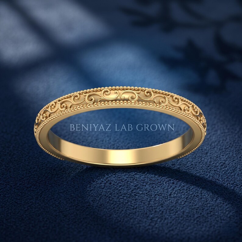 Yellow gold antique scroll stackable wedding band with ornate engraved pattern and milgrain edges, slim vintage band for bridal stacking.