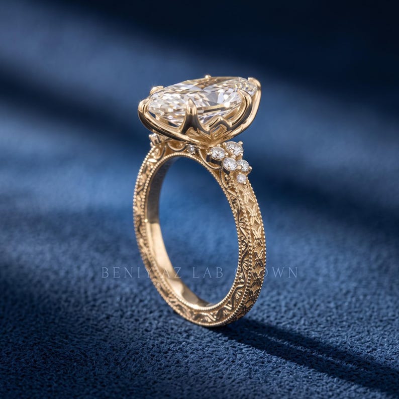 Side profile of a 3 CT marquise lab grown diamond ring showing the raised centre stone and pave set yellow gold band.