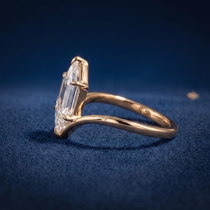 Side profile of a Dutch Marquise lab grown diamond ring showing the raised prong setting and polished yellow gold V shank.