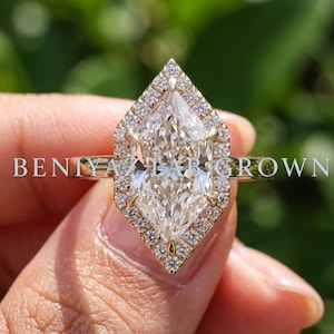 Three quarter view of a Dutch marquise lab grown diamond ring with geometric pavé halo and minimalist 1.80 mm gold shank.