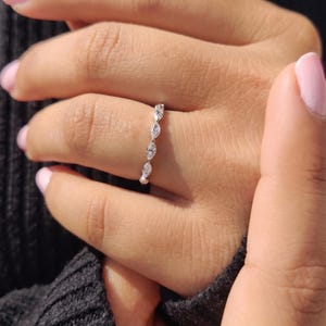 Side angle of dainty marquise and round lab grown diamond half eternity ring showing slim plain band