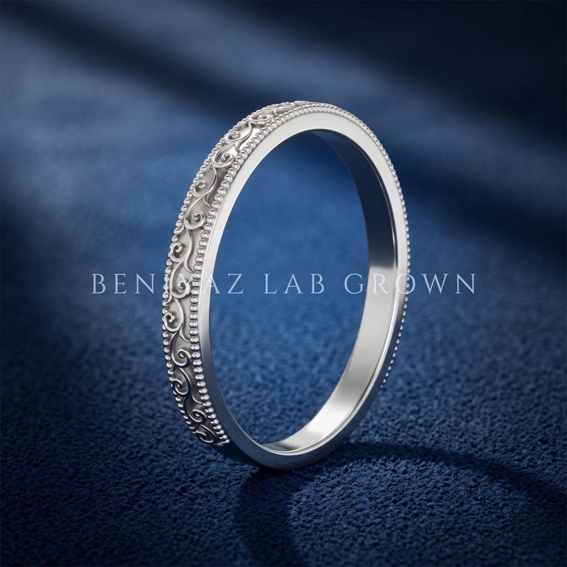 White gold antique engraved stackable band with scroll detailing and beaded milgrain edges, elegant slim wedding ring side profile.