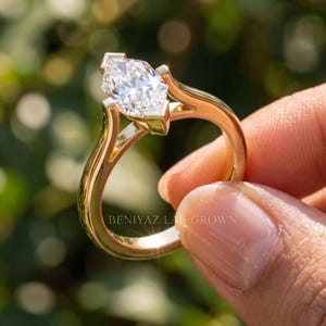 Side profile of Dutch marquise lab grown diamond engagement ring showing the raised solitaire setting and slim polished band.