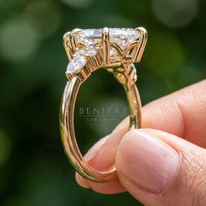 Rear view of marquise diamond engagement ring showing decorative open gallery, side stone clusters and slim polished shank