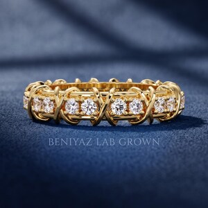 Front studio view of a lab grown diamond crossover wedding band featuring round brilliant stones in a full eternity geometric design.