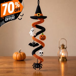 May include: A hanging crochet spiral decoration featuring a black witch hat at the top, followed by a white ghost, an orange jack-o'-lantern, a black bat, a white skull, and a black spider dangling from the orange and black yarn structure.