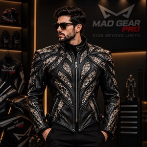 May include: A black leather jacket featuring intricate, textured, light-colored panels with a snakeskin-like pattern. The jacket has a high collar, a full-length front zipper, and structured shoulder detailing, worn over a black shirt.