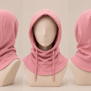 May include: A solid dusty pink hooded neck warmer featuring a fitted hood with a rounded opening, a wide collar that covers the upper chest and shoulders, and two matching fabric drawstrings hanging down from the front of the hood opening.