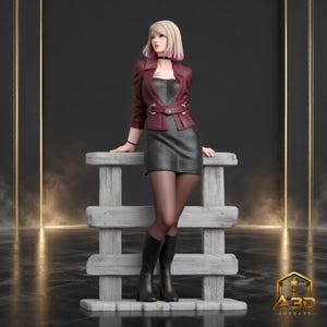 May include: A collectible figurine of a blonde person with pink-tipped hair, wearing a maroon jacket over a black strapless dress, a black choker, and black boots, leaning against a gray wooden fence structure with the A3D AMORA3D logo.
