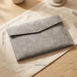 May include: A grey envelope-style document sleeve with a textured finish and a pointed flap closure. The sleeve measures 240mm by 330mm, as indicated by the measurement lines printed on the image, providing a clear view of its dimensions.