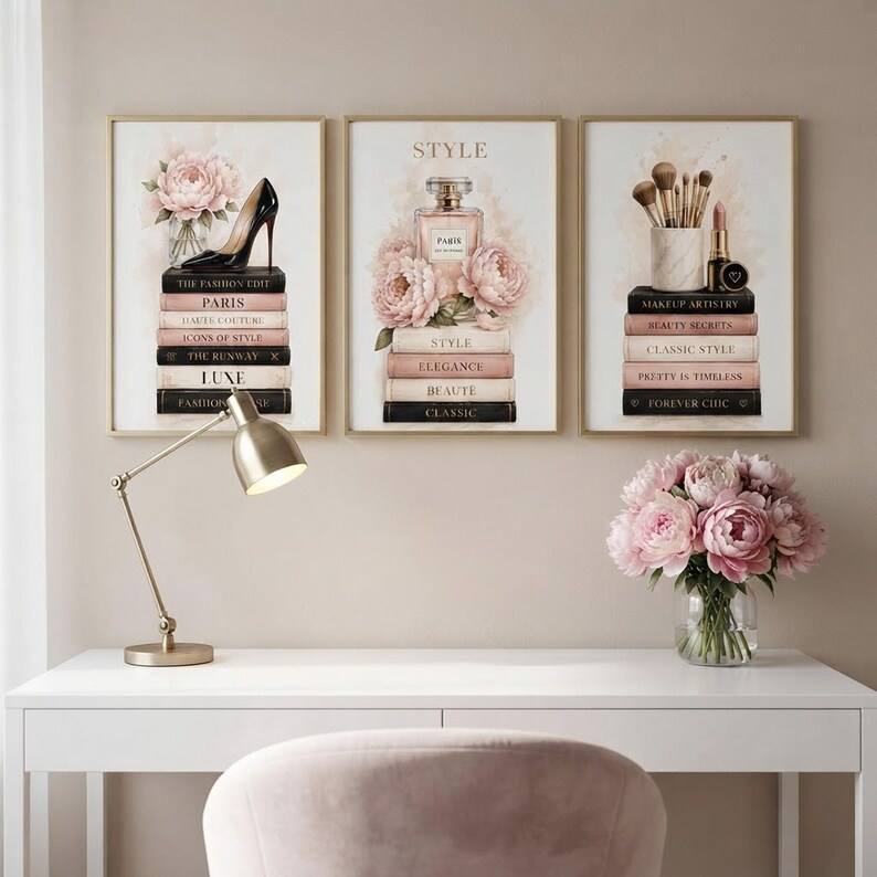 The three fashion prints displayed together on a beige accent wall in a bright, feminine home office.