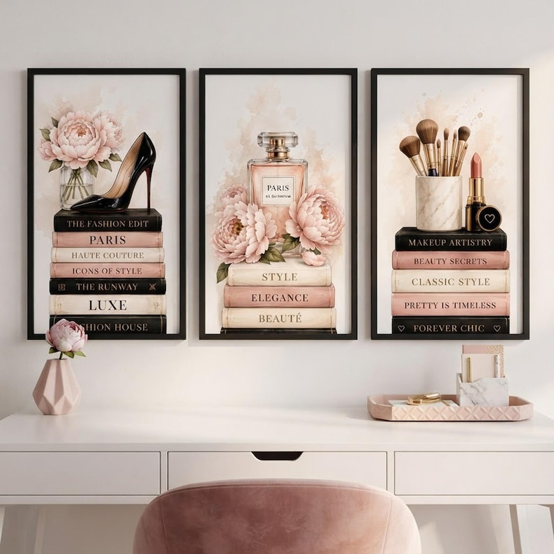 The set of three fashion wall art prints hanging in black frames above a clean white modern office desk.