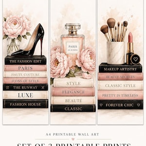 A set of three vertical fashion prints featuring watercolor illustrations of a high heel, a perfume bottle, and makeup brushes resting on stacks of books.