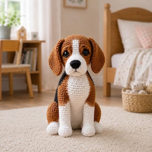 May include: A crochet beagle dog toy featuring a tri-colour pattern of brown, white, and black yarn. The stuffed animal has large dark eyes, floppy ears, and a white chest and muzzle, sitting upright with a textured, hand-stitched appearance.