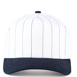 May include: White baseball cap with vertical black pinstripes and a navy blue brim. The cap has a rounded crown and a button on top. This classic style is suitable for sports or casual wear.