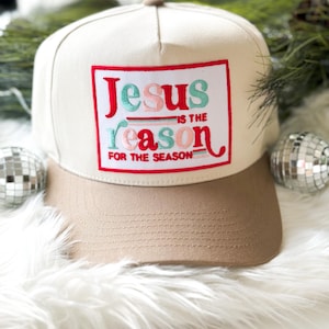 May include: A beige and brown baseball cap with a red, white, and green embroidered patch that says "Jesus is the reason for the season".