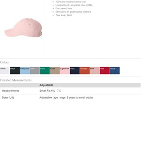 May include: A pink, unstructured, six-panel, low-profile baseball cap with a pre-curved visor and a self-fabric tri-glide buckle closure. The cap is made of 100% bio-washed chino twill and has a tear-away label.