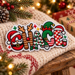 May include: A decorative embroidered patch featuring the name CHACE in a festive holiday style. Each letter is uniquely designed with Christmas motifs including a Santa Claus, reindeer antlers, a decorated tree, an elf hat, and red plaid.