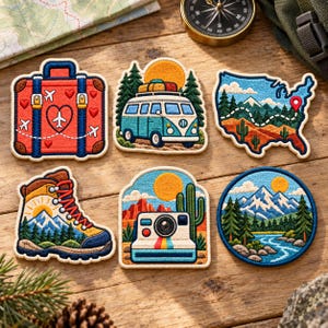 May include: Six embroidered patches featuring travel themes: a red suitcase with airplanes, a blue camper van in a forest, a map of the USA with a route, a hiking boot with mountains, a vintage camera with a cactus, and a circular mountain lake scene.