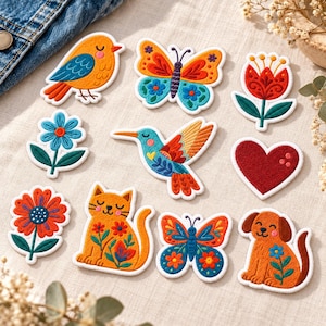 May include: A collection of ten embroidered iron-on patches featuring colorful designs including a bird, two butterflies, a tulip, a blue flower, a hummingbird, a red heart, a sunflower, a cat, and a dog, all with detailed stitching.