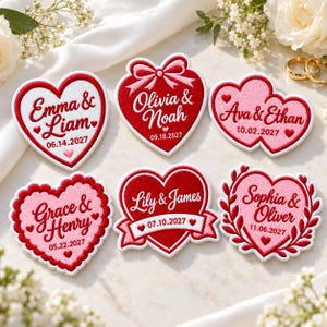 May include: Six heart-shaped embroidered patches featuring names and dates. The patches display the text Emma & Liam 06.14.2027, Olivia & Noah 09.18.2027, Ava & Ethan 10.02.2027, Grace & Henry 05.22.2027, Lily & James 07.10.2027, and Sophia & Oliver 11.06.2027.
