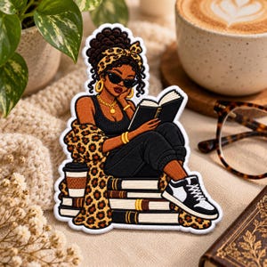 May include: An embroidered patch featuring a person with dark skin and curly hair wearing a leopard print headband, black sunglasses, a black tank top, and a leopard print cardigan, sitting on a stack of books while reading and holding a coffee cup.